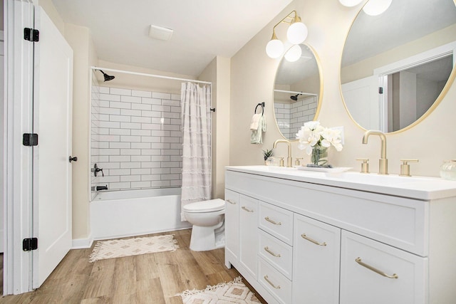 320 Calhoun St, Union City, MI 49094 - full bath featuring double vanity, shower / bathtub combination with curtain, wood finished floors, and toilet
