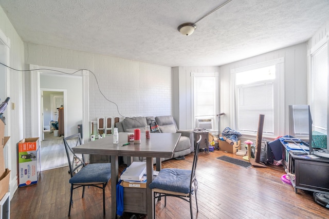 1007 Ionia Ave SW, Grand Rapids, MI 49507 - dining area featuring wood-type flooring and a textured ceiling
