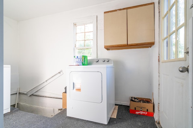 1007 Ionia Ave SW, Grand Rapids, MI 49507 - washroom featuring washer / dryer, cabinet space, and carpet flooring