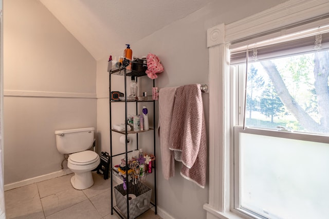 1007 Ionia Ave SW, Grand Rapids, MI 49507 - bathroom with lofted ceiling, toilet, tile patterned floors, and baseboards