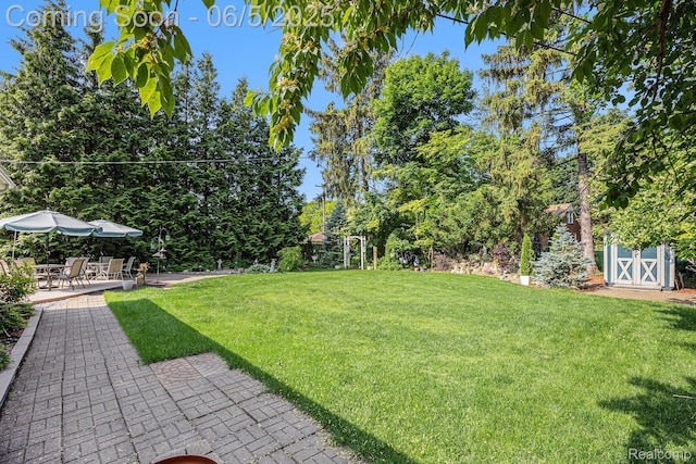 15025 Kipke, Redford, MI 48239 - view of grassy yard with a patio and view of wooded area