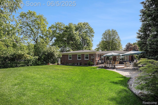 15025 Kipke, Redford, MI 48239 - back of property with brick siding, a lawn, and a patio area
