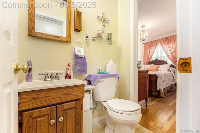 15025 Kipke, Redford, MI 48239 - half bath featuring vanity, toilet, baseboards, a chandelier, and ensuite bathroom