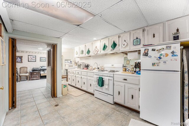 15025 Kipke, Redford, MI 48239 - kitchen featuring white appliances, white cabinets, light countertops, a paneled ceiling, and light tile patterned floors