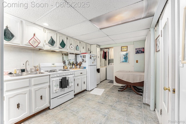 15025 Kipke, Redford, MI 48239 - kitchen featuring white appliances, a sink, a paneled ceiling, washer / dryer, and white cabinets