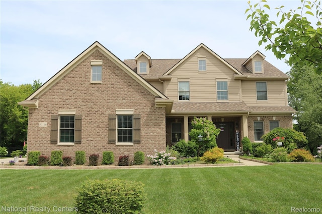 26998 Hampstead Blvd, Farmington Hills, MI 48331 - view of front of property with a front yard, brick siding, and roof with shingles