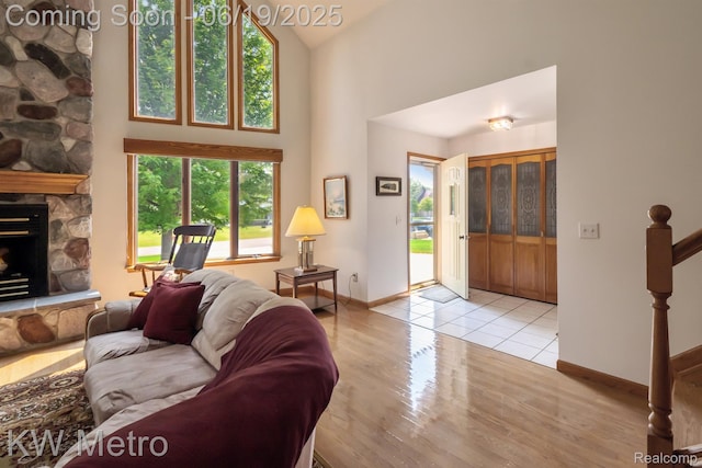 4333 Running Deer Trl, Pigeon, MI 48755 - living room with plenty of natural light, wood finished floors, a stone fireplace, and a high ceiling