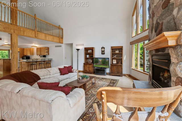 4333 Running Deer Trl, Pigeon, MI 48755 - living area with a high ceiling, light wood finished floors, a fireplace, and healthy amount of natural light