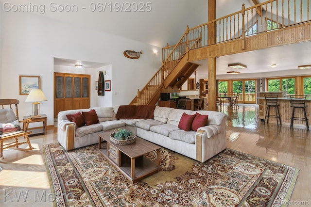 4333 Running Deer Trl, Pigeon, MI 48755 - living area with stairway, high vaulted ceiling, and wood finished floors