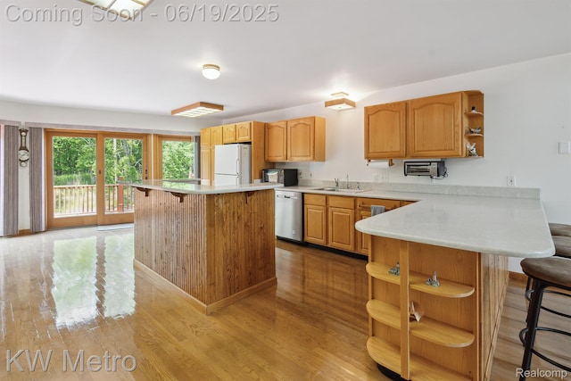 4333 Running Deer Trl, Pigeon, MI 48755 - kitchen featuring open shelves, stainless steel dishwasher, freestanding refrigerator, a breakfast bar, and light wood-style flooring