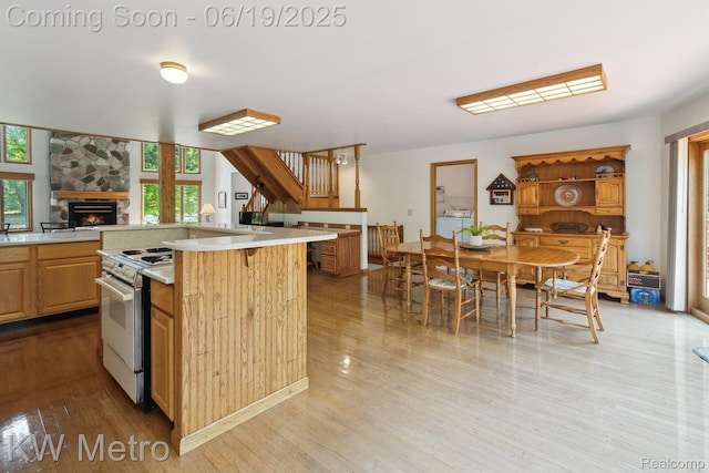 4333 Running Deer Trl, Pigeon, MI 48755 - kitchen with white stove, light countertops, plenty of natural light, and light wood finished floors