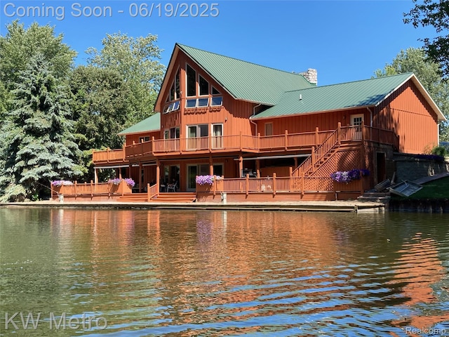 4333 Running Deer Trl, Pigeon, MI 48755 - back of house featuring a metal roof, a chimney, a deck with water view, and a standing seam roof