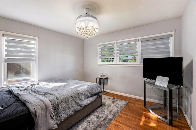 21406 Broadstone St, Harper Woods, MI 48225 - bedroom featuring a chandelier, wood finished floors, and baseboards