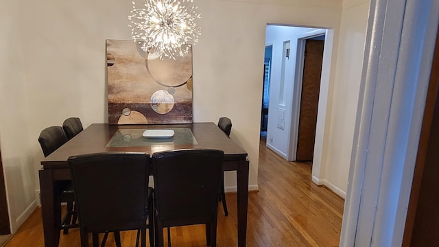 21406 Broadstone St, Harper Woods, MI 48225 - dining area with wood finished floors, a chandelier, and baseboards