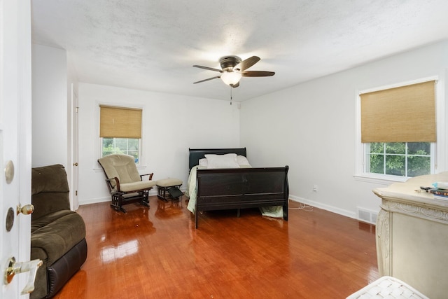 15501 E Jefferson Ave, Grosse Pointe Park, MI 48230 - bedroom featuring multiple windows, wood finished floors, and baseboards