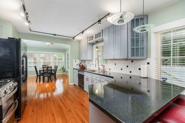 15501 E Jefferson Ave, Grosse Pointe Park, MI 48230 - kitchen featuring rail lighting, dishwasher, a sink, and range with two ovens