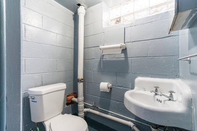 15501 E Jefferson Ave, Grosse Pointe Park, MI 48230 - half bathroom with toilet, concrete block wall, and a sink