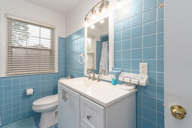 15501 E Jefferson Ave, Grosse Pointe Park, MI 48230 - full bathroom with tile walls, vanity, toilet, tile patterned flooring, and a shower with curtain