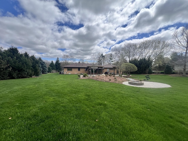 3817 Butterworth St SW, Grand Rapids, MI 49534 - view of grassy yard with a fire pit