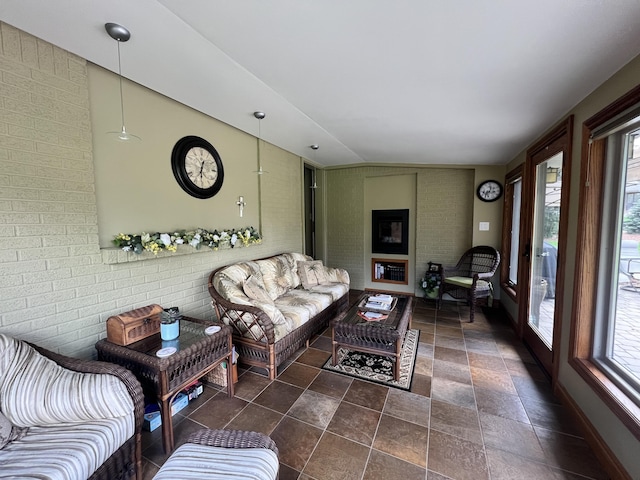 3817 Butterworth St SW, Grand Rapids, MI 49534 - living area featuring stone finish floors and brick wall