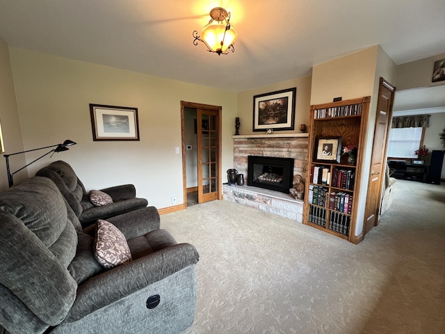 3817 Butterworth St SW, Grand Rapids, MI 49534 - carpeted living area with a stone fireplace and baseboards