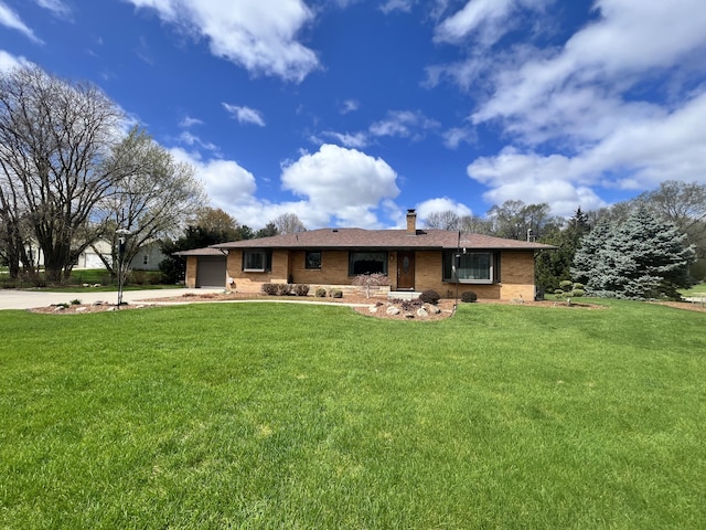 3817 Butterworth St SW, Grand Rapids, MI 49534 - view of front of property with brick siding, a front lawn, a chimney, and concrete driveway