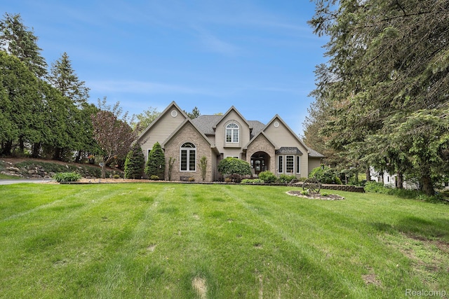 1437 Rillview Ct, Metamora, MI 48455 - view of front facade with a front lawn, stone siding, and brick siding