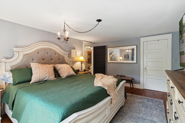 700 S Washington, Mount Pleasant, MI 48858 - bedroom featuring a chandelier, baseboards, and dark wood-style flooring