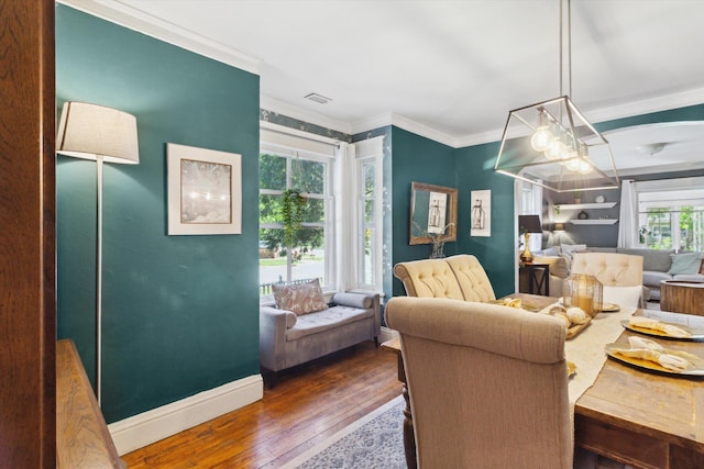 700 S Washington, Mount Pleasant, MI 48858 - dining area with dark wood-style floors, crown molding, baseboards, and a chandelier