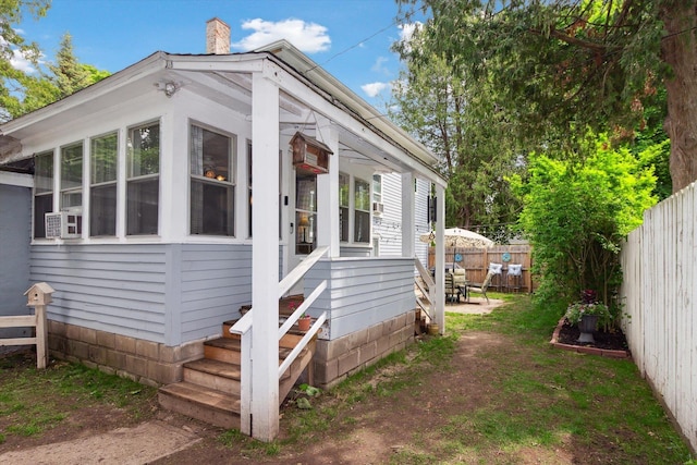 700 S Washington, Mount Pleasant, MI 48858 - view of property exterior with a fenced backyard, a chimney, and entry steps