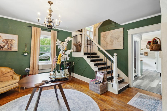 700 S Washington, Mount Pleasant, MI 48858 - living room with wood finished floors, a chandelier, stairway, crown molding, and baseboards