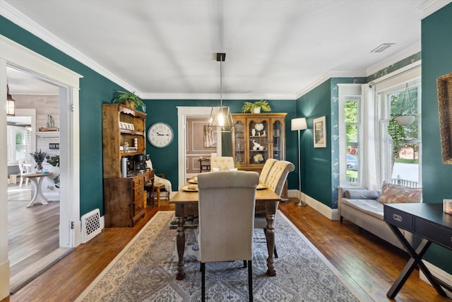 700 S Washington, Mount Pleasant, MI 48858 - dining area with hardwood / wood-style flooring, baseboards, and crown molding