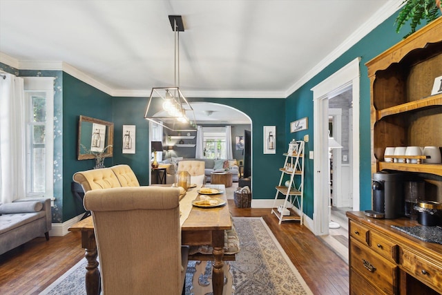700 S Washington, Mount Pleasant, MI 48858 - dining space featuring arched walkways, dark wood-style flooring, crown molding, and baseboards