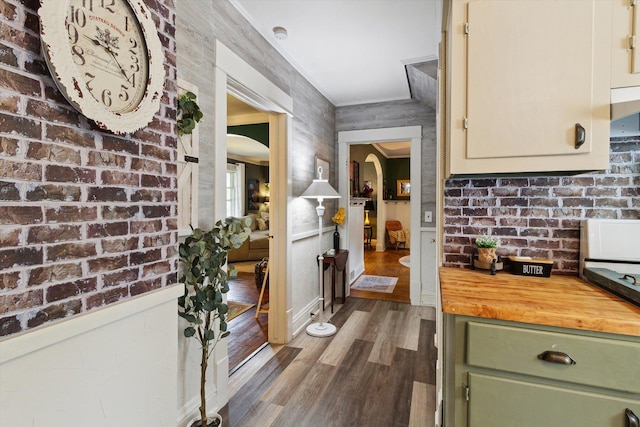 700 S Washington, Mount Pleasant, MI 48858 - kitchen with green cabinets, wooden counters, dark wood-style flooring, baseboards, and crown molding