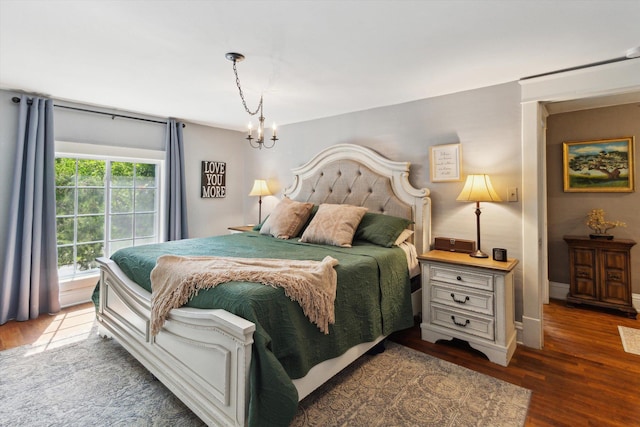 700 S Washington, Mount Pleasant, MI 48858 - bedroom with wood finished floors, a chandelier, baseboards, and access to exterior