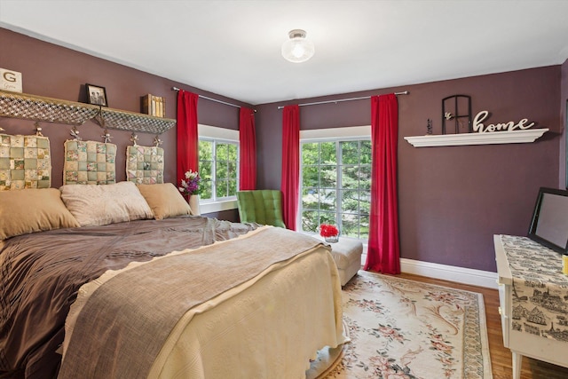 700 S Washington, Mount Pleasant, MI 48858 - bedroom featuring baseboards and wood finished floors