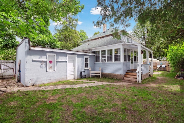 700 S Washington, Mount Pleasant, MI 48858 - back of house featuring a chimney, a sunroom, and roof with shingles