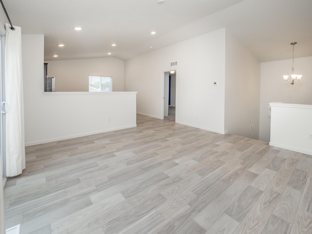 1925 Prescott Trl, Galesburg, MI 49053 - spare room featuring a chandelier, light wood-style floors, recessed lighting, vaulted ceiling, and baseboards
