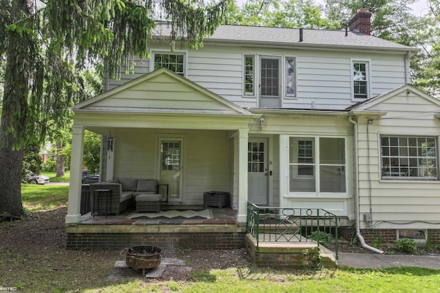 1118 Maxine St, Flint, MI 48503 - rear view of house featuring a chimney and covered porch