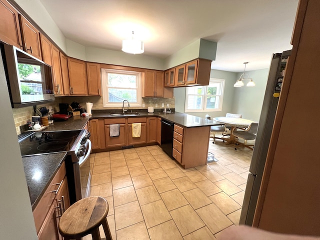 2304 Hickory Point Dr N, Portage, MI 49024 - kitchen with appliances with stainless steel finishes, decorative backsplash, and healthy amount of natural light
