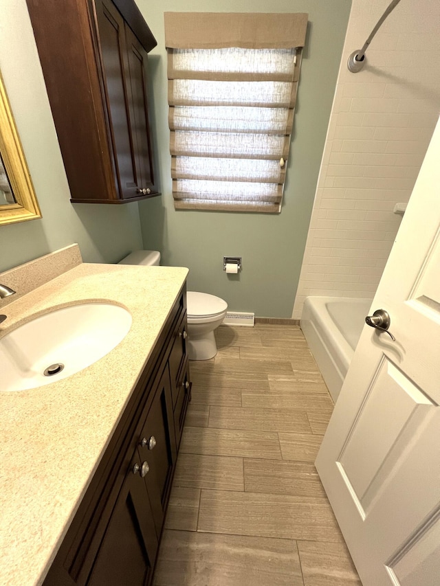 2304 Hickory Point Dr N, Portage, MI 49024 - bathroom featuring vanity, toilet, wood finished floors, and bathing tub / shower combination