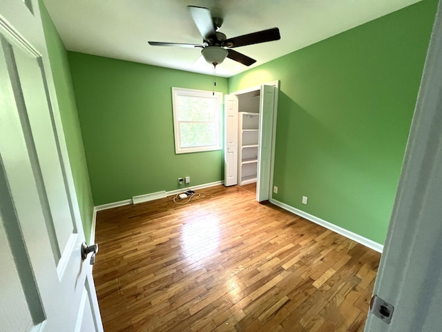 2304 Hickory Point Dr N, Portage, MI 49024 - unfurnished bedroom with wood finished floors, baseboards, ceiling fan, and a closet
