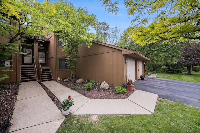 7643 Cottonwood Ln, Dexter, MI 48130 - view of side of property with asphalt driveway