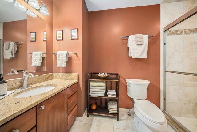 7643 Cottonwood Ln, Dexter, MI 48130 - full bathroom featuring toilet, vanity, a shower stall, tile patterned flooring, and baseboards