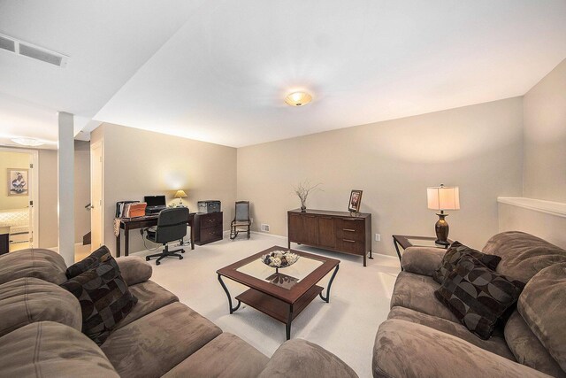 7643 Cottonwood Ln, Dexter, MI 48130 - living area featuring light colored carpet, a desk, and baseboards
