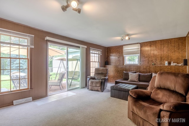2153 Greenview Ct SW, Wyoming, MI 49519 - living room with light colored carpet, wooden walls, and a ceiling fan