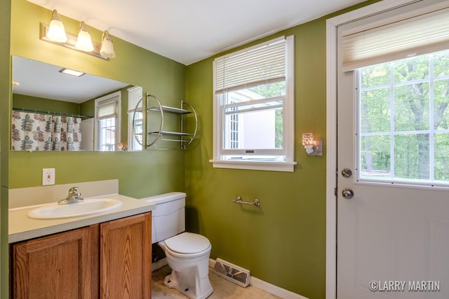 2153 Greenview Ct SW, Wyoming, MI 49519 - bathroom featuring healthy amount of natural light, toilet, and vanity