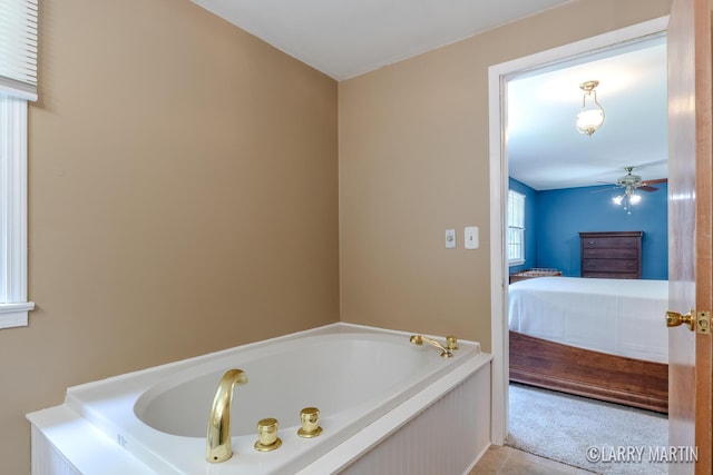 2153 Greenview Ct SW, Wyoming, MI 49519 - full bathroom featuring a garden tub, ensuite bath, ceiling fan, and tile patterned floors