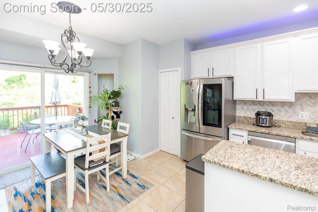 2062 Preserve Cir W, Canton, MI 48188 - kitchen with stainless steel appliances, decorative backsplash, white cabinetry, a chandelier, and light tile patterned flooring