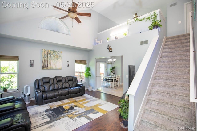 2062 Preserve Cir W, Canton, MI 48188 - living room featuring stairs, ceiling fan, wood finished floors, a chandelier, and high vaulted ceiling